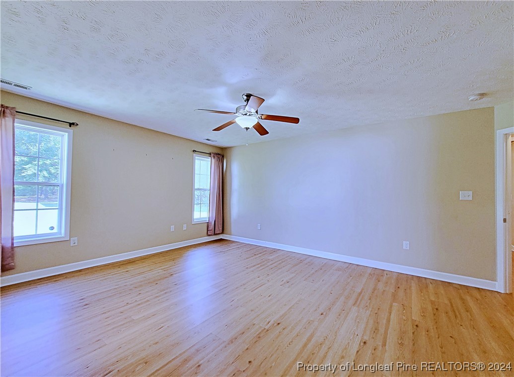 235 Chestnut Drive Raeford, NC 28376 - Photo 27 of 50 wooden floor in an empty room with a window