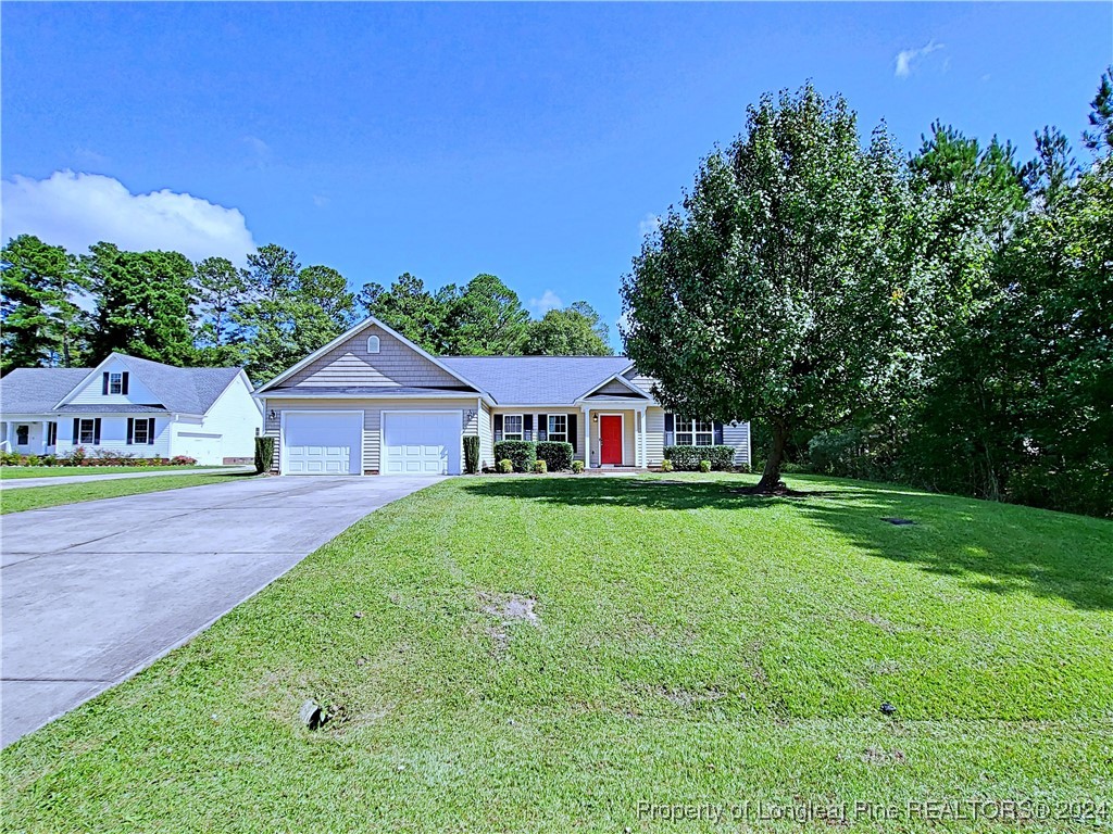 235 Chestnut Drive Raeford, NC 28376 - Photo 3 of 50 a view of a house with yard and a garden