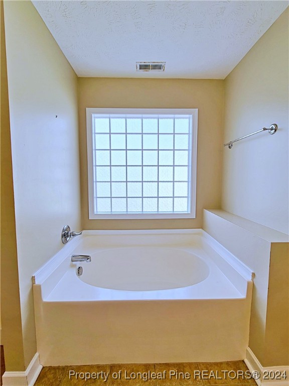 235 Chestnut Drive Raeford, NC 28376 - Photo 31 of 50 a bathroom with a bathtub and shower