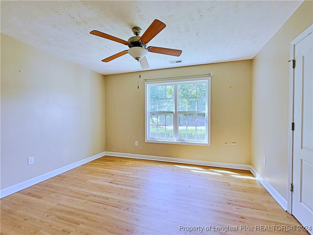 235 Chestnut Drive Raeford, NC 28376 - Photo 36 of 50 a view of an empty room with wooden floor and a window