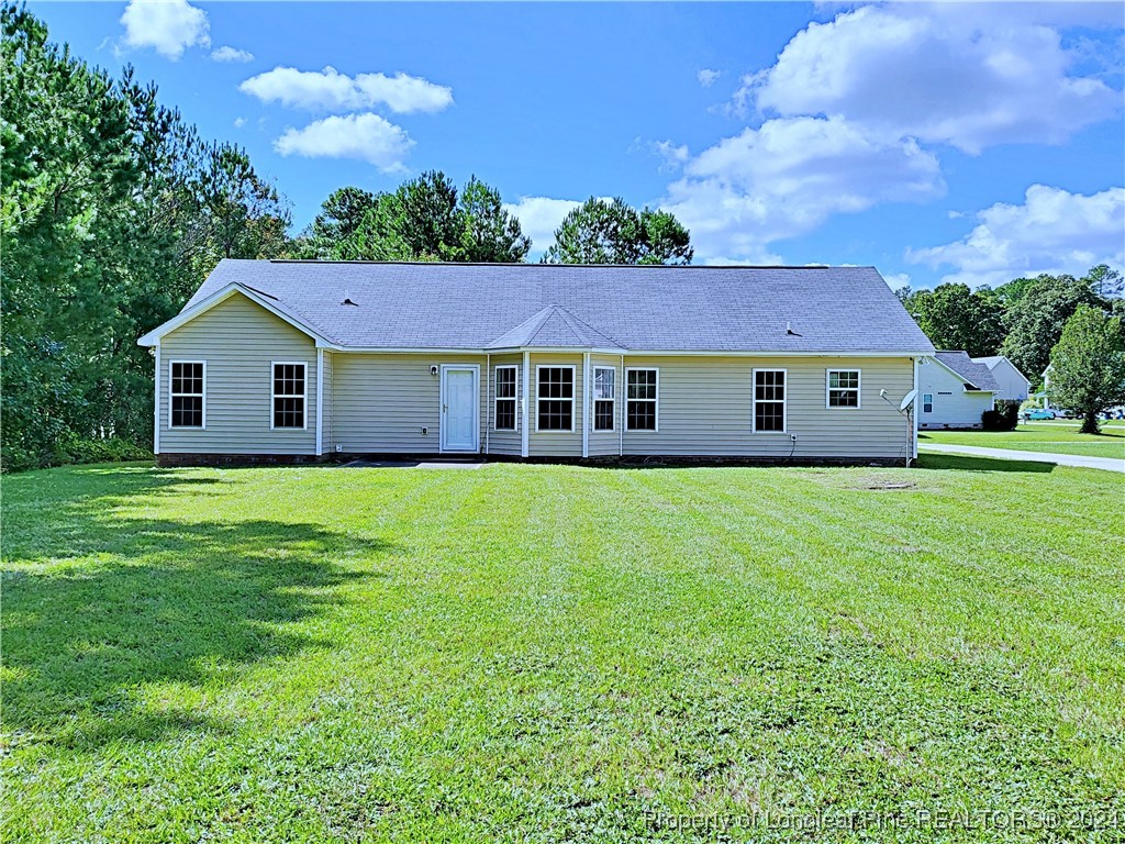 235 Chestnut Drive Raeford, NC 28376 - Photo 46 of 50 a view of a house with a big yard potted plants and large tree