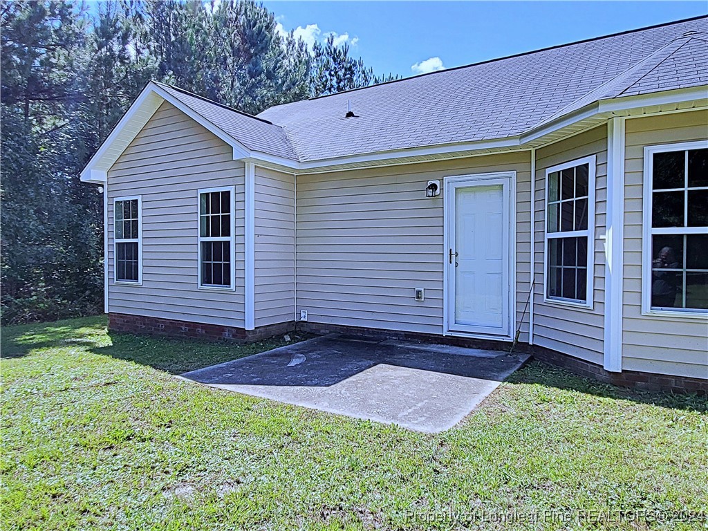 235 Chestnut Drive Raeford, NC 28376 - Photo 47 of 50 a front view of a house with a yard