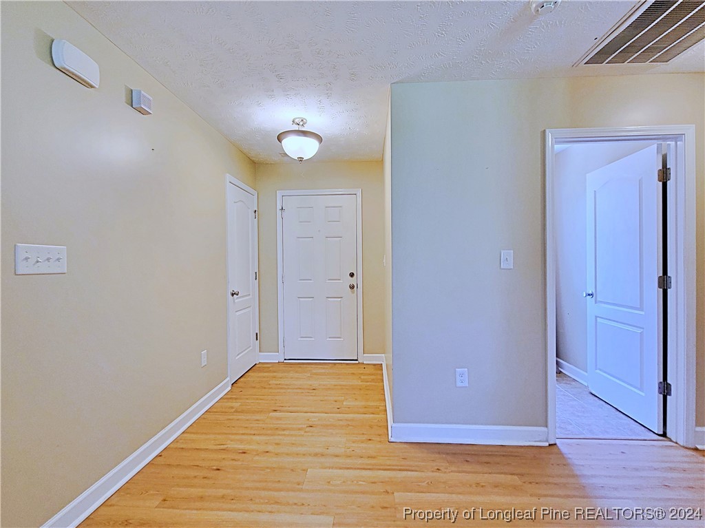 235 Chestnut Drive Raeford, NC 28376 - Photo 8 of 50 a view of a livingroom with wooden floor and closet