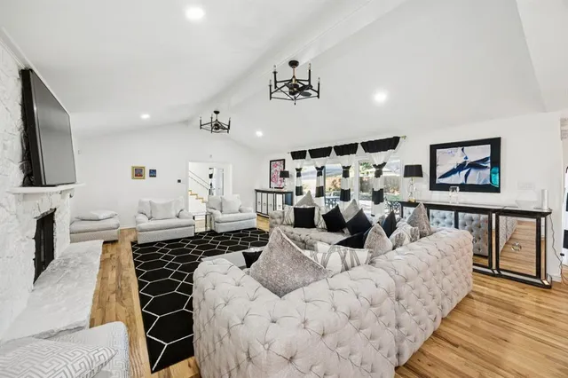 a living room with furniture a rug and a fireplace