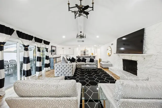 a living room with furniture a clock and wooden floor