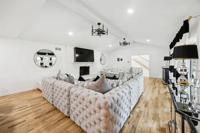 a spacious bedroom with a bed and flat screen tv