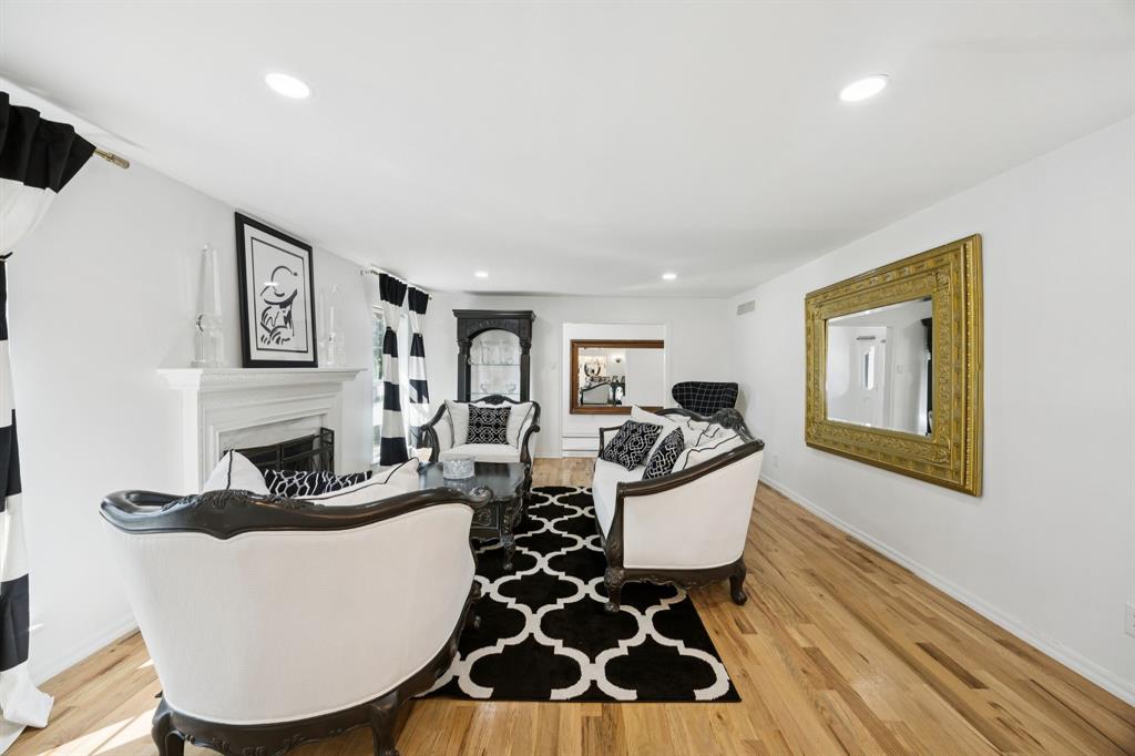 11212 Inwood Road Dallas, TX 75229 - Photo 15 of 36 a living room with furniture a rug and a fireplace