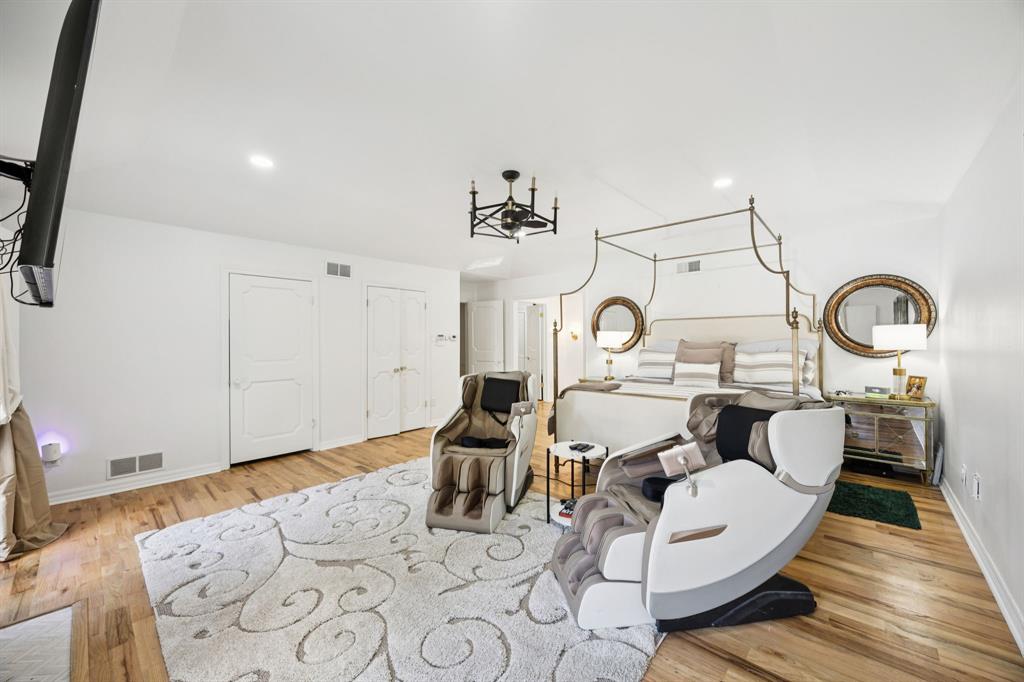 11212 Inwood Road Dallas, TX 75229 - Photo 16 of 36 a living room with furniture a clock and wooden floor