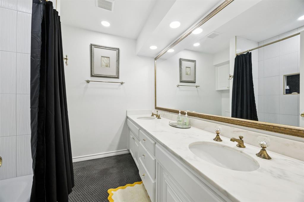 11212 Inwood Road Dallas, TX 75229 - Photo 21 of 36 a bathroom with a double vanity sink and a mirror