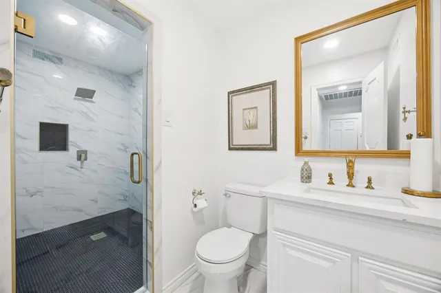 a bedroom with a bed and a desk next to a window