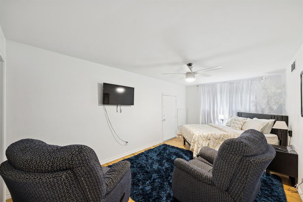 11212 Inwood Road Dallas, TX 75229 - Photo 23 of 36 a living room with furniture a couch and a flat screen tv