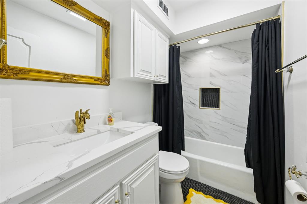 11212 Inwood Road Dallas, TX 75229 - Photo 24 of 36 a bathroom with a sink a toilet and shower