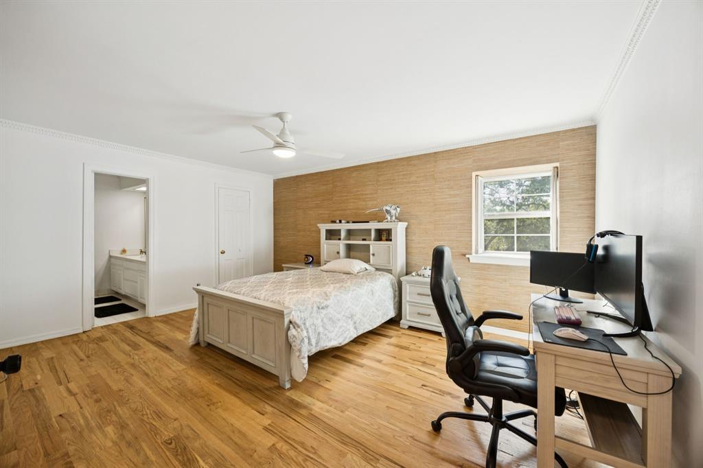 11212 Inwood Road Dallas, TX 75229 - Photo 30 of 36 a bedroom with a bed and a desk next to a window
