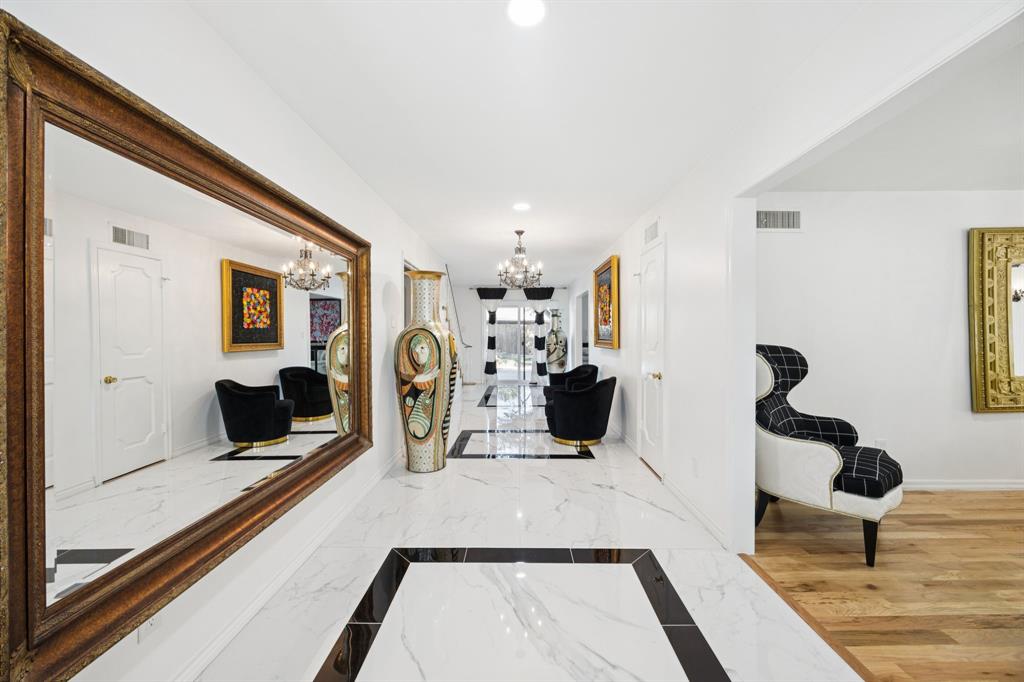 11212 Inwood Road Dallas, TX 75229 - Photo 4 of 36 a living room with furniture a flat screen tv and a large window