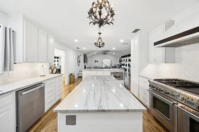 a view of a dining room with furniture and chandelier