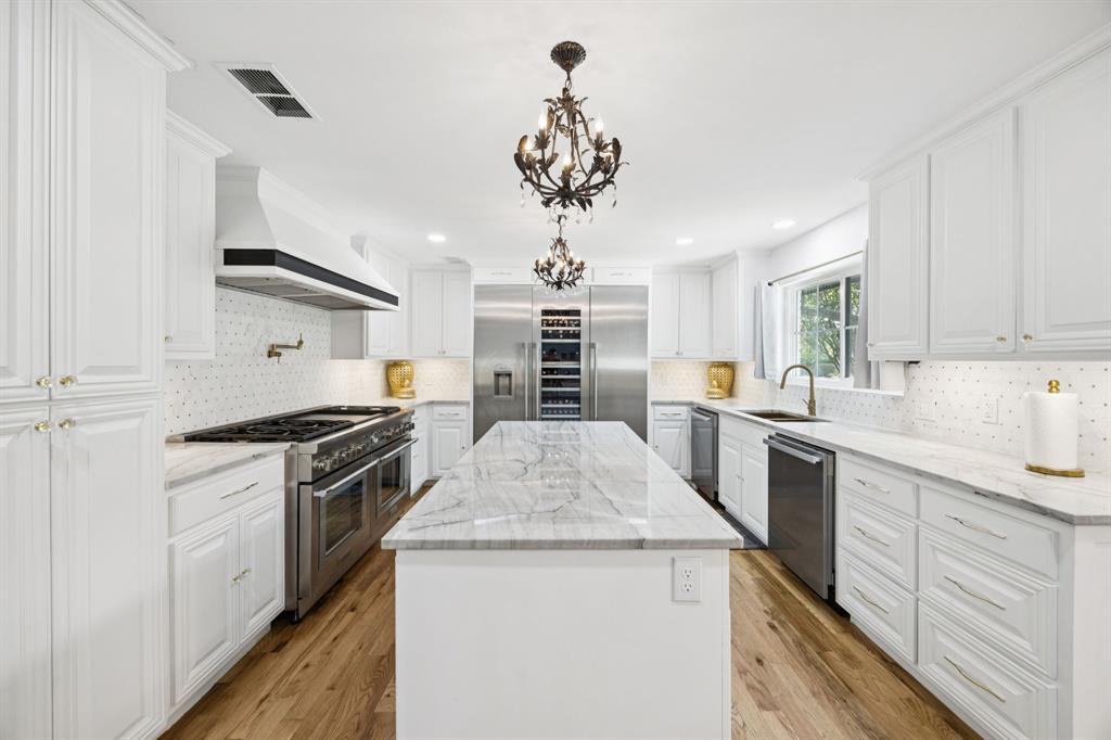 11212 Inwood Road Dallas, TX 75229 - Photo 7 of 36 a kitchen with stainless steel appliances granite countertop a sink stove and refrigerator