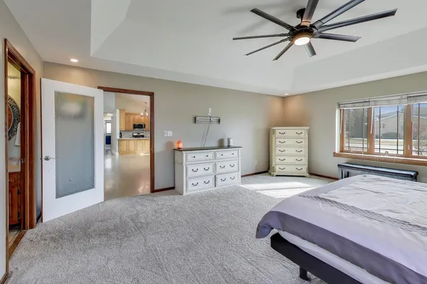 a bedroom with a bed and a chandelier