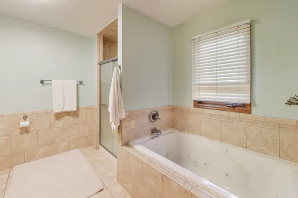 a bathroom with a bathtub and a shower