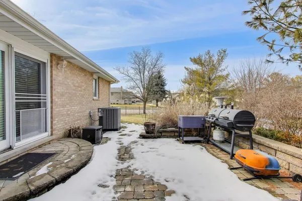 a backyard of a house with fire pit and furniture