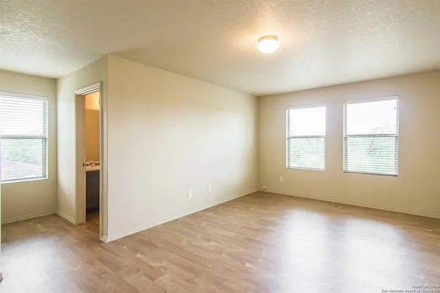 an empty room with windows and closet