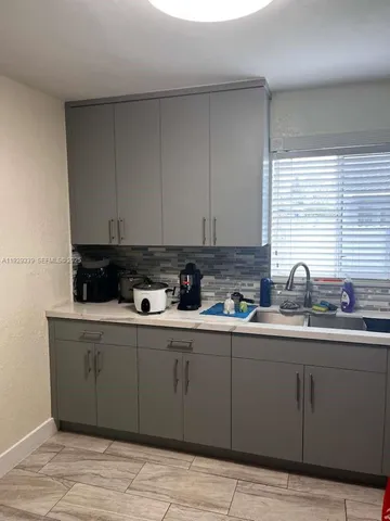 a kitchen with a sink and cabinets