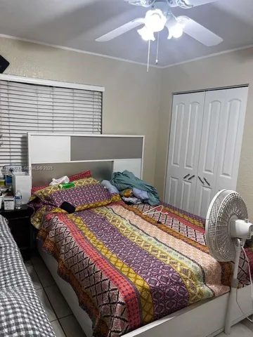 a bedroom with bed and a window