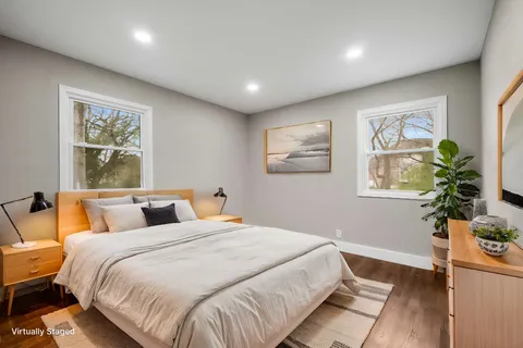 a view of empty room with wooden floor and window