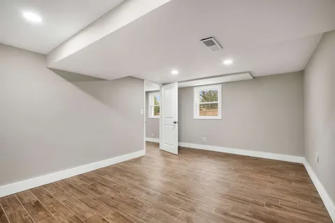 a view of a house with backyard and trees