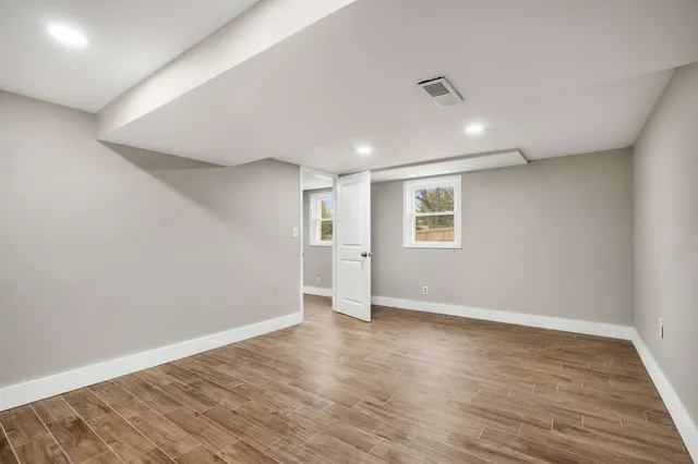 a view of a house with backyard and trees