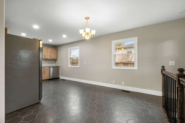 a kitchen with granite countertop a sink a stove and cabinets