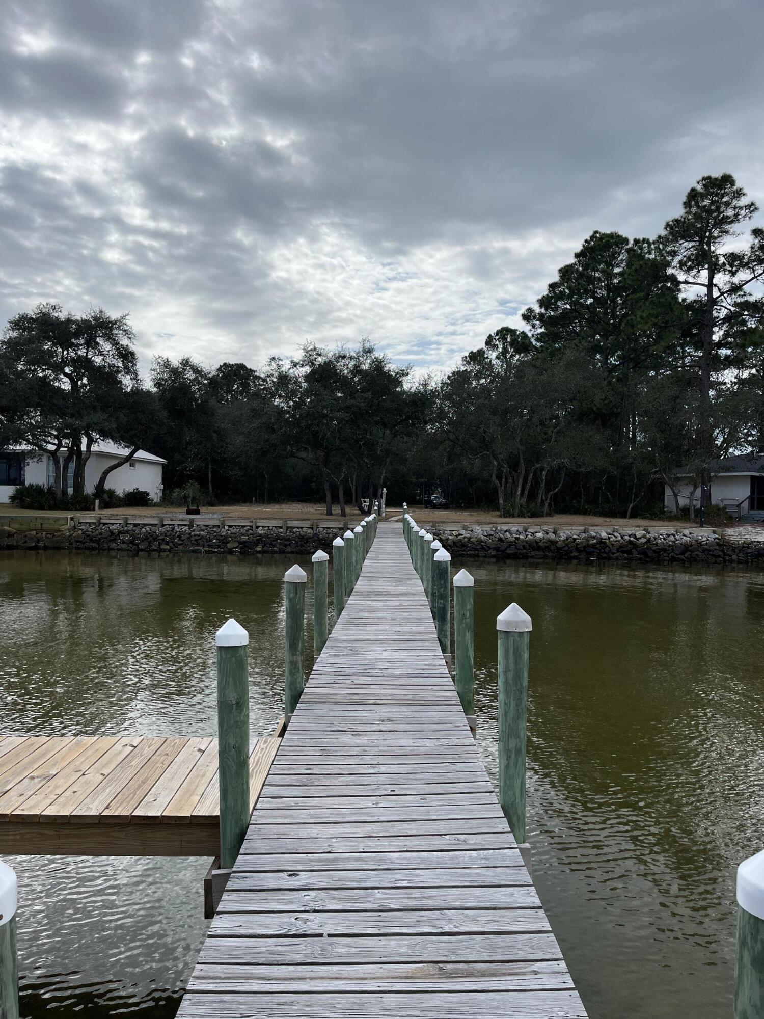 431 Pisces Drive Santa Rosa Beach, FL 32459 - Photo 14 of 19 a wooden pier with boats in a lake