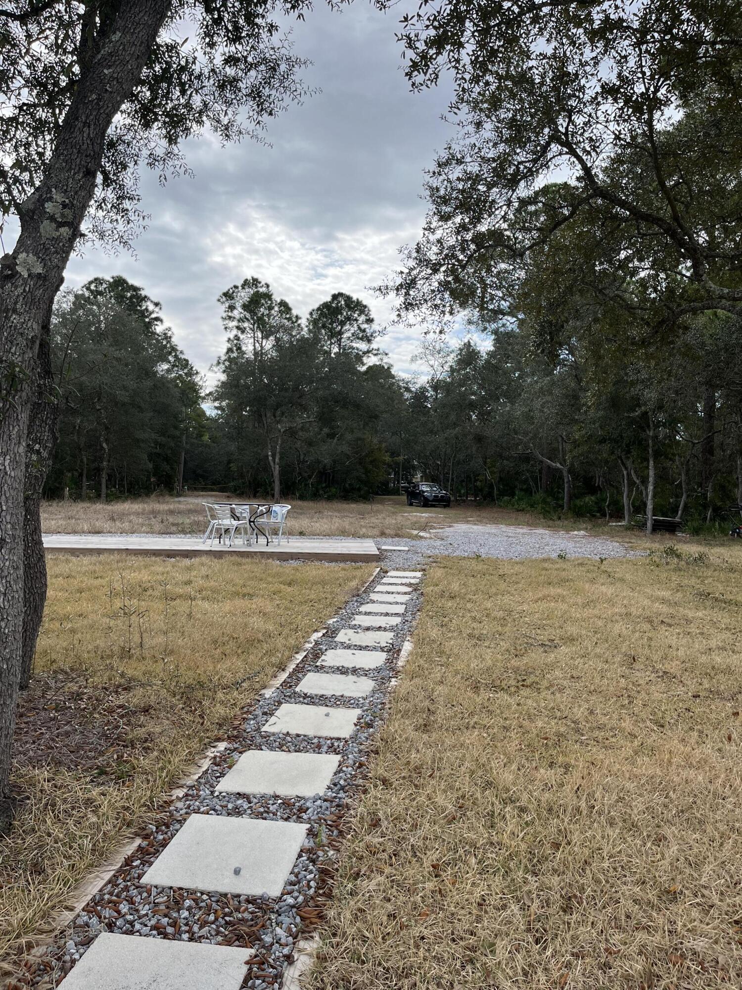 431 Pisces Drive Santa Rosa Beach, FL 32459 - Photo 17 of 19 a view of a swimming pool with a yard