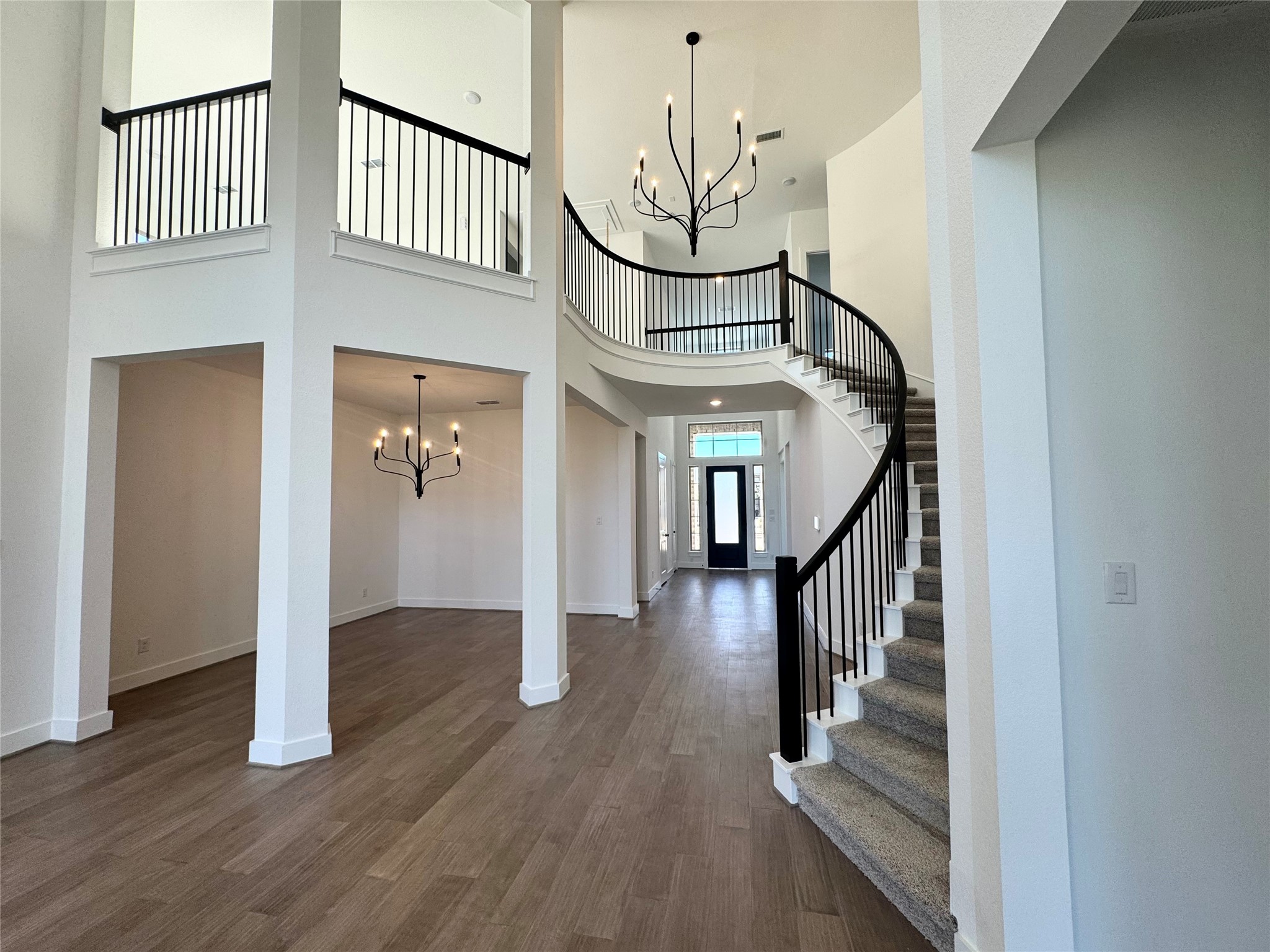 4307 Southpoint Way Fulshear, TX 77441 - Photo 3 of 18 a view of staircase with white walls and wooden floor