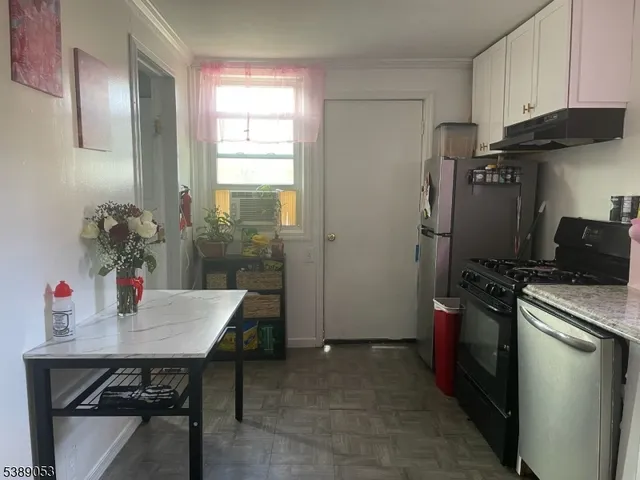 a kitchen with a table and chairs in it