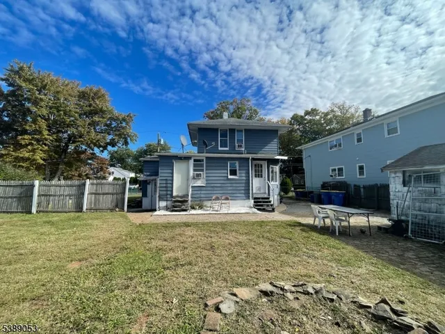 a backyard of a house with table and chairs
