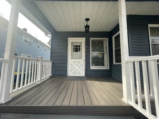 a view of house with a big yard and potted plants