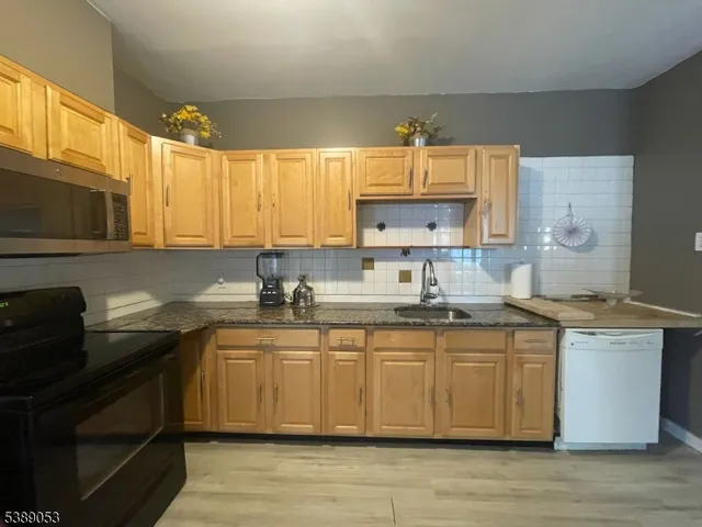 a kitchen with a sink cabinets and window