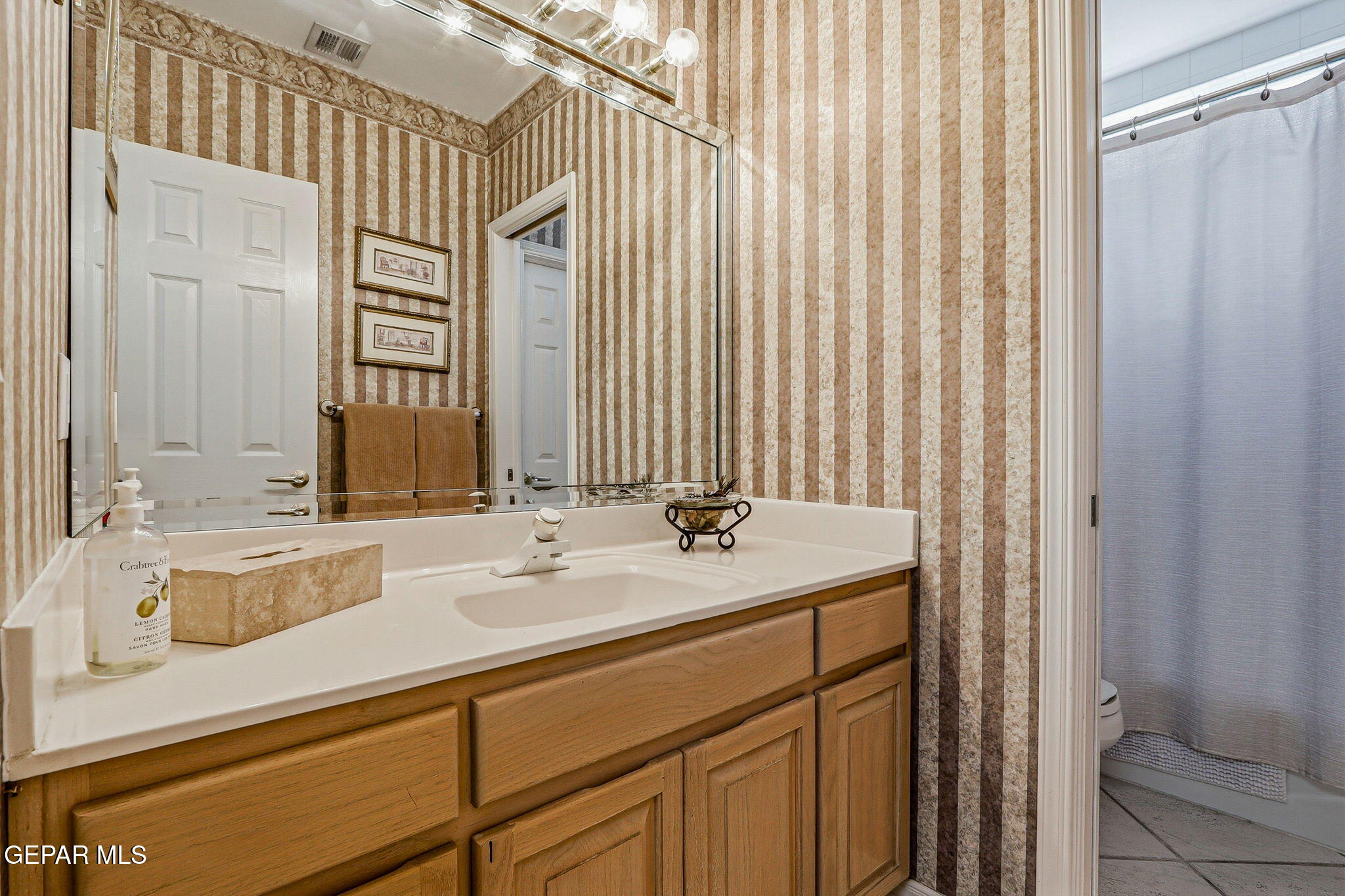 5806 Diamond Point Circle El Paso, TX 79912 - Photo 22 of 61 a bathroom with a sink and a mirror