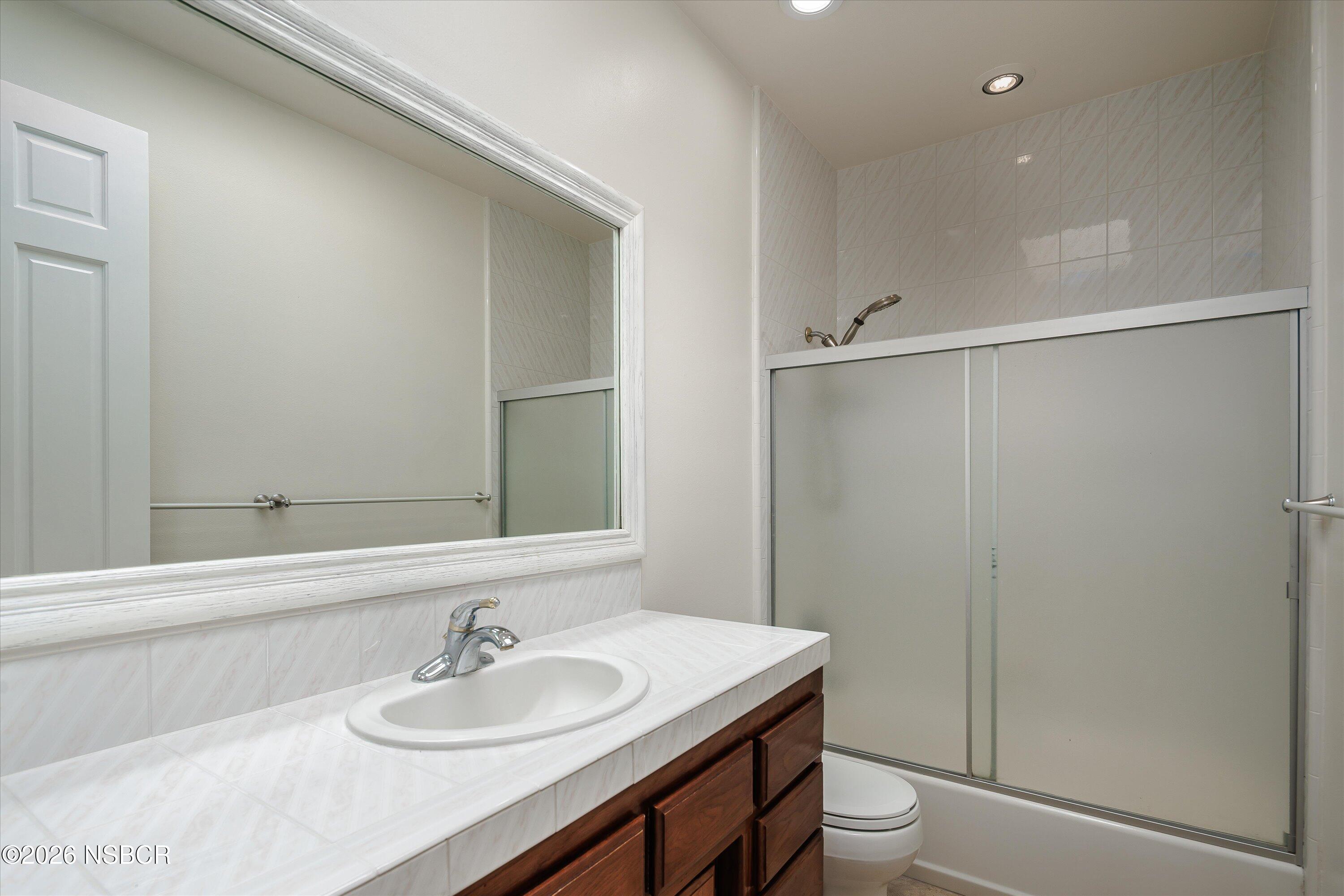2655 Adobe Falls Road Lompoc, CA 93436 - Photo 36 of 51 a bathroom with a granite countertop sink toilet and a mirror
