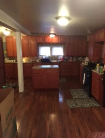a kitchen with sink cabinets and wooden floor