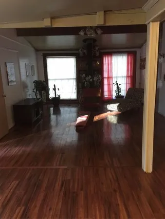 a view of a living room and hardwood floor