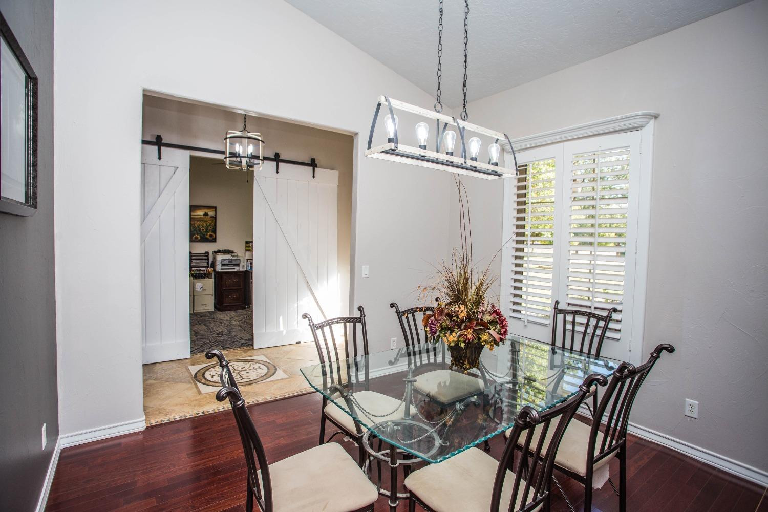 7516 66th Street Lubbock, TX 79407 - Photo 14 of 50 a view of a dining room with furniture window and wooden floor