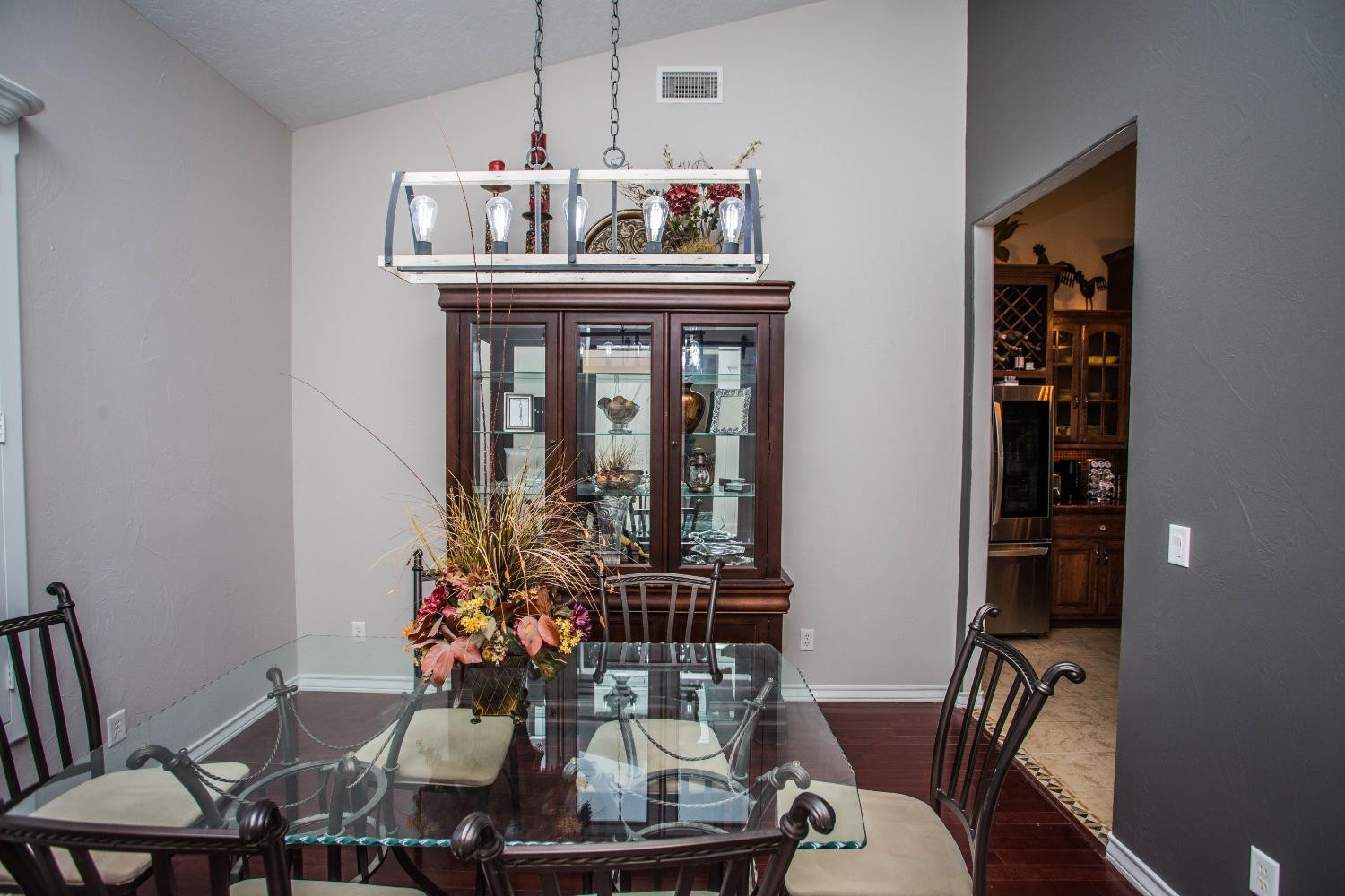 7516 66th Street Lubbock, TX 79407 - Photo 15 of 50 a dining room with furniture and wooden floor