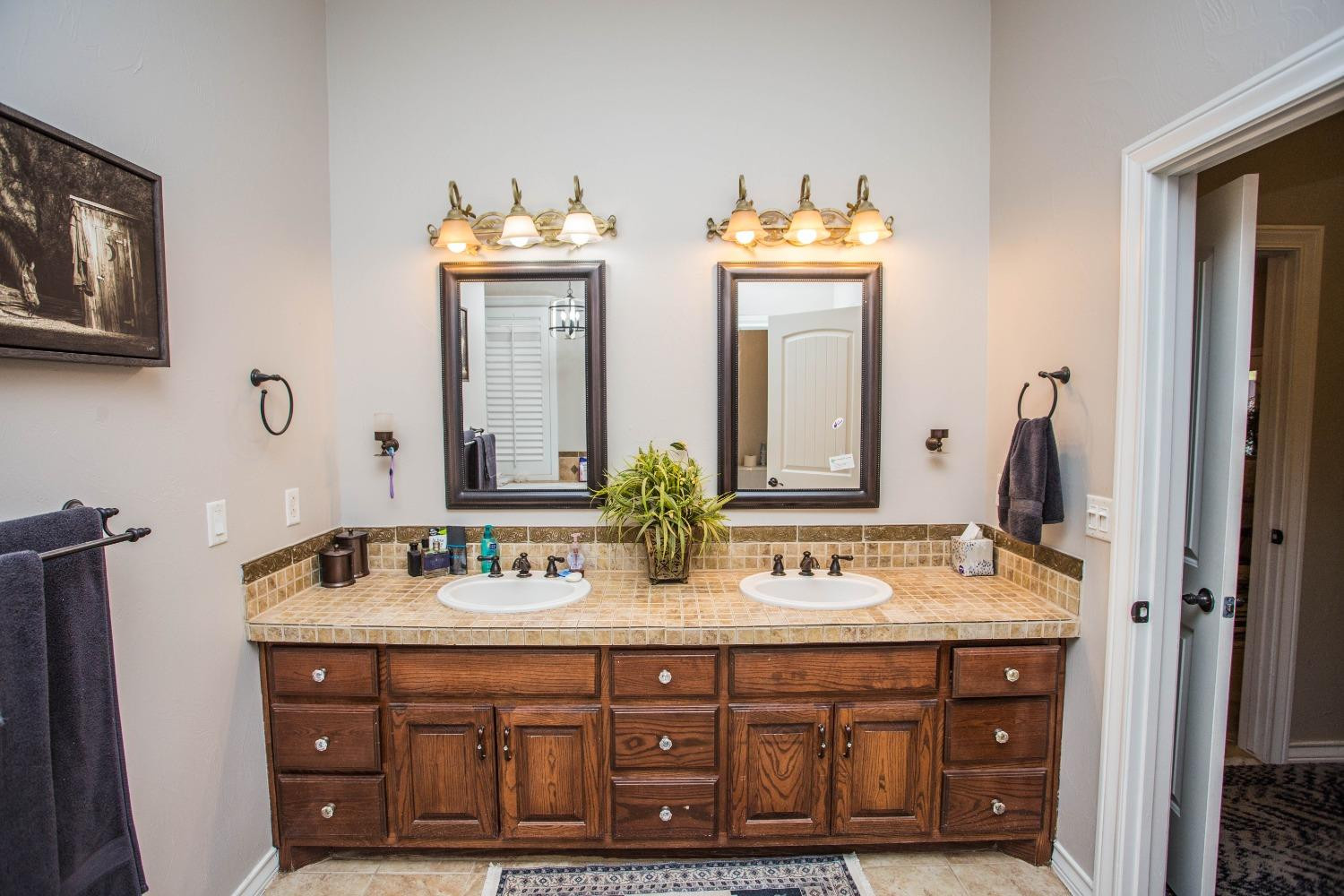 7516 66th Street Lubbock, TX 79407 - Photo 20 of 50 a bathroom with double sink and a mirror