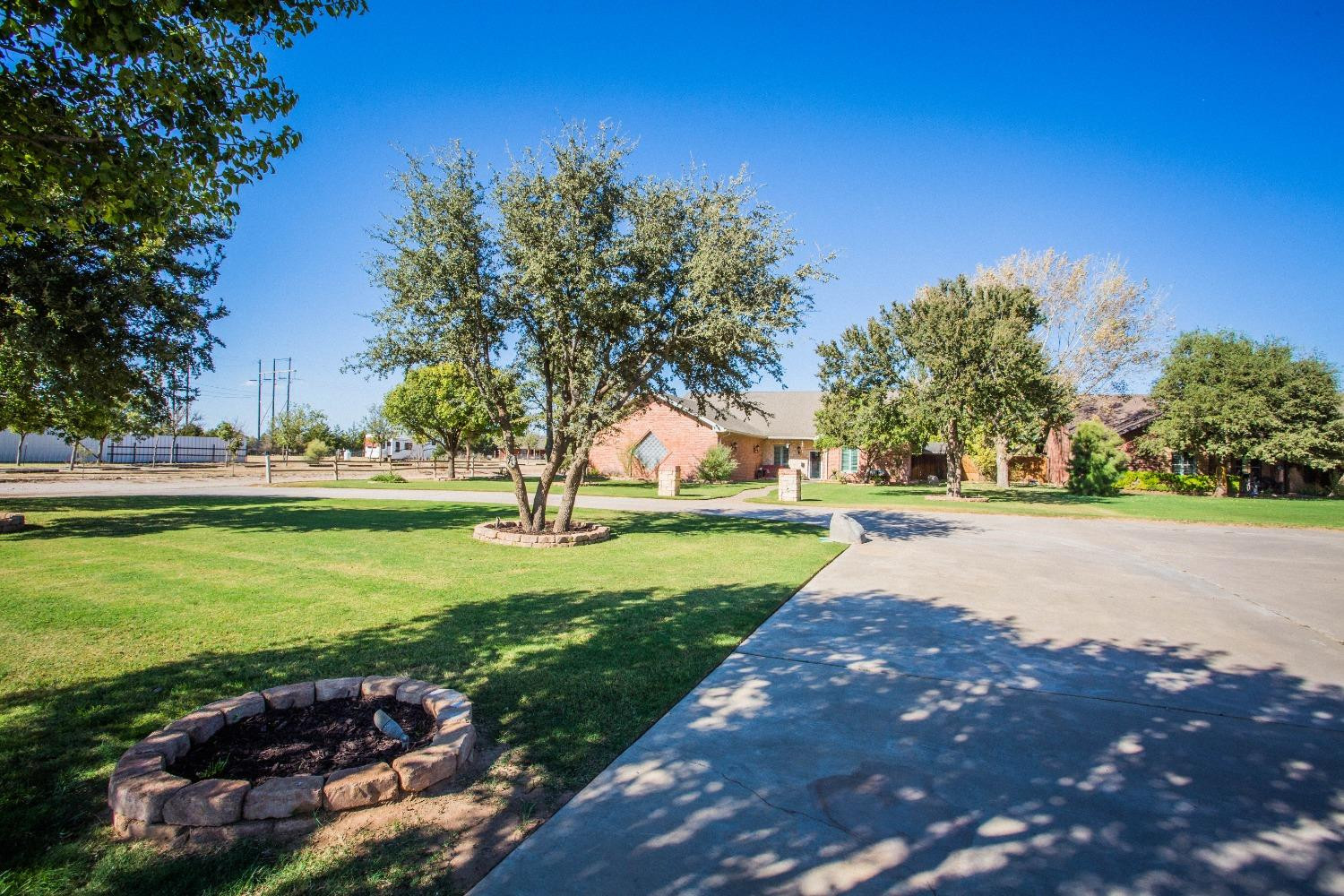 7516 66th Street Lubbock, TX 79407 - Photo 2 of 50 a view of yard with swimming pool and green space