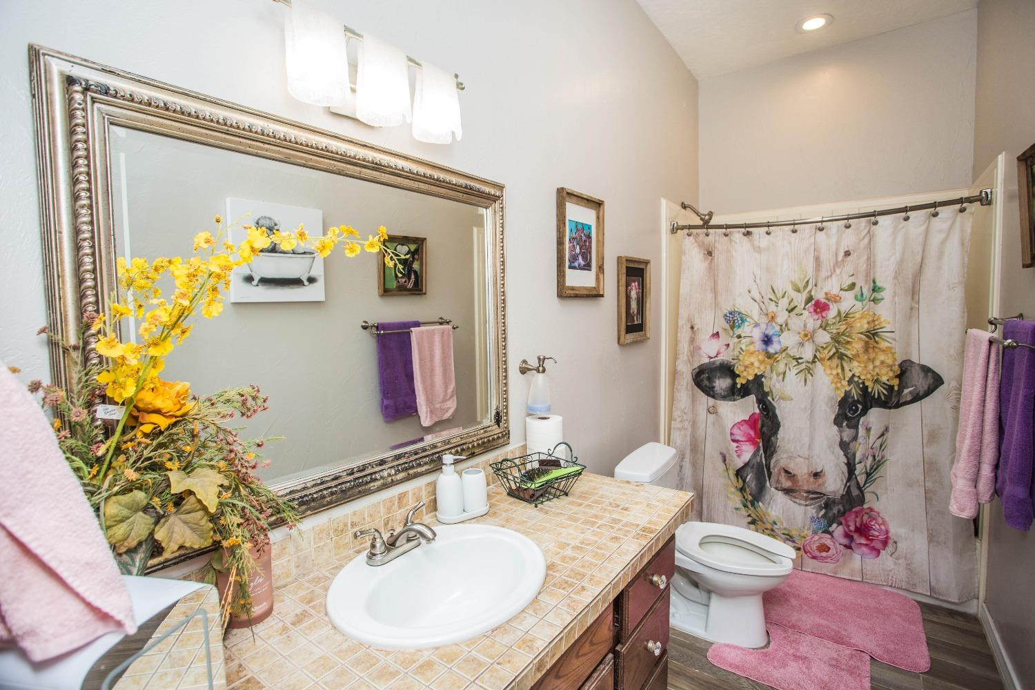 7516 66th Street Lubbock, TX 79407 - Photo 27 of 50 a bathroom with a sink mirror and toilet