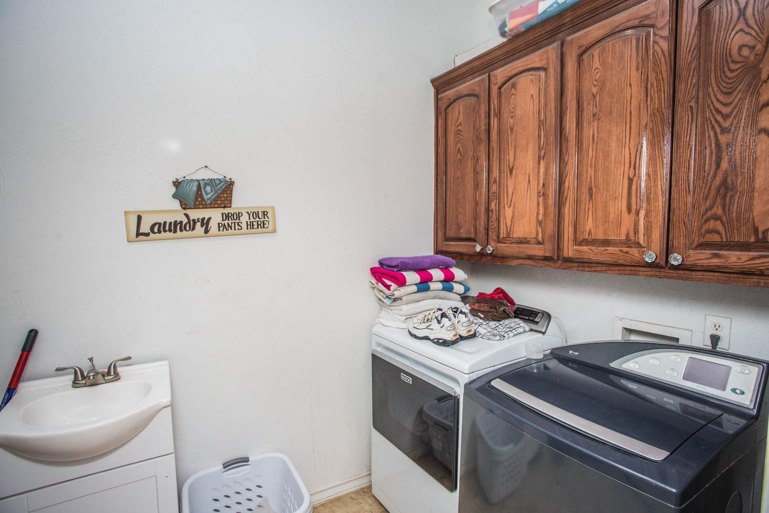 7516 66th Street Lubbock, TX 79407 - Photo 32 of 50 a utility room with sink dryer and washer