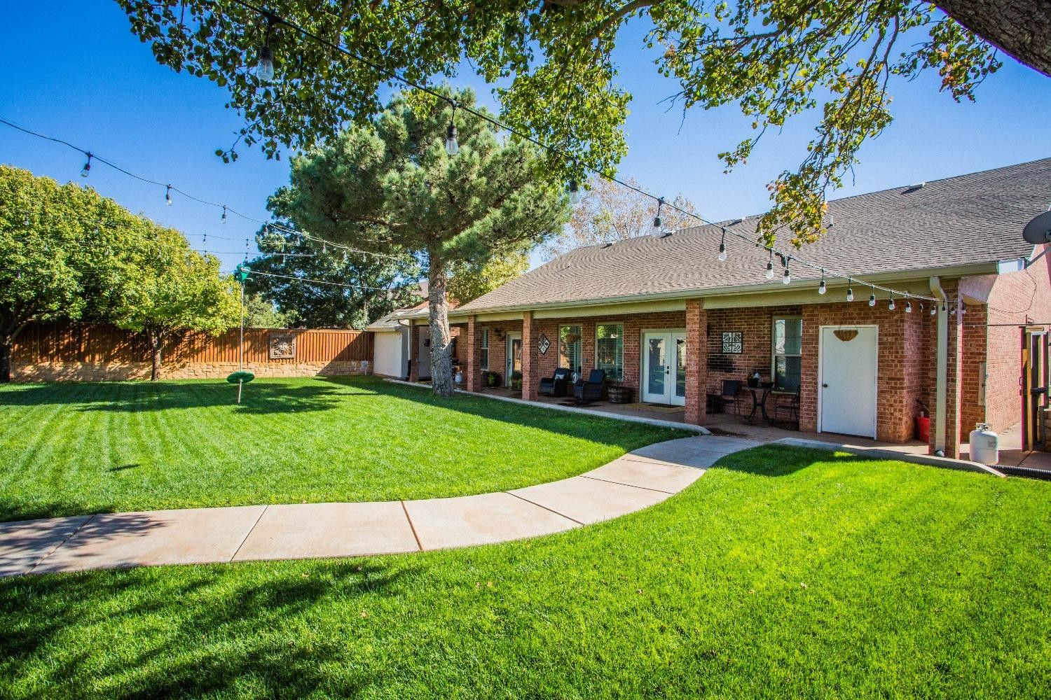 7516 66th Street Lubbock, TX 79407 - Photo 34 of 50 a view of a house with a yard porch and sitting area