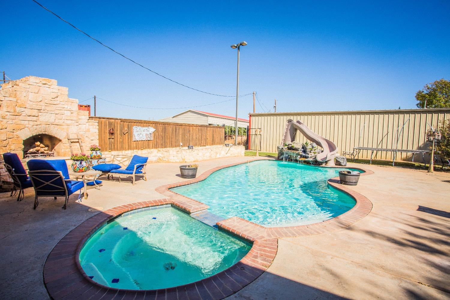 7516 66th Street Lubbock, TX 79407 - Photo 38 of 50 a view of a swimming pool in a backyard