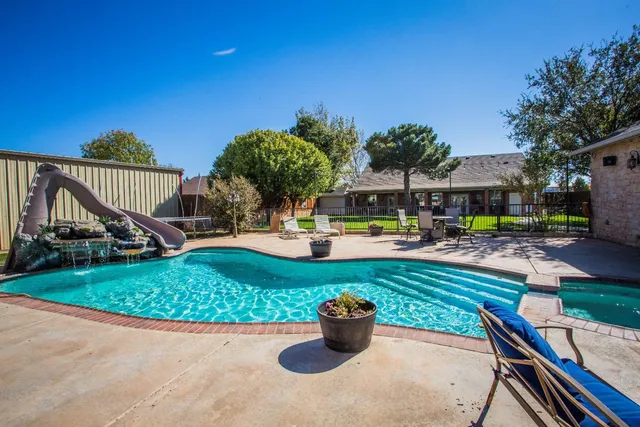 a view of a swimming pool with a patio